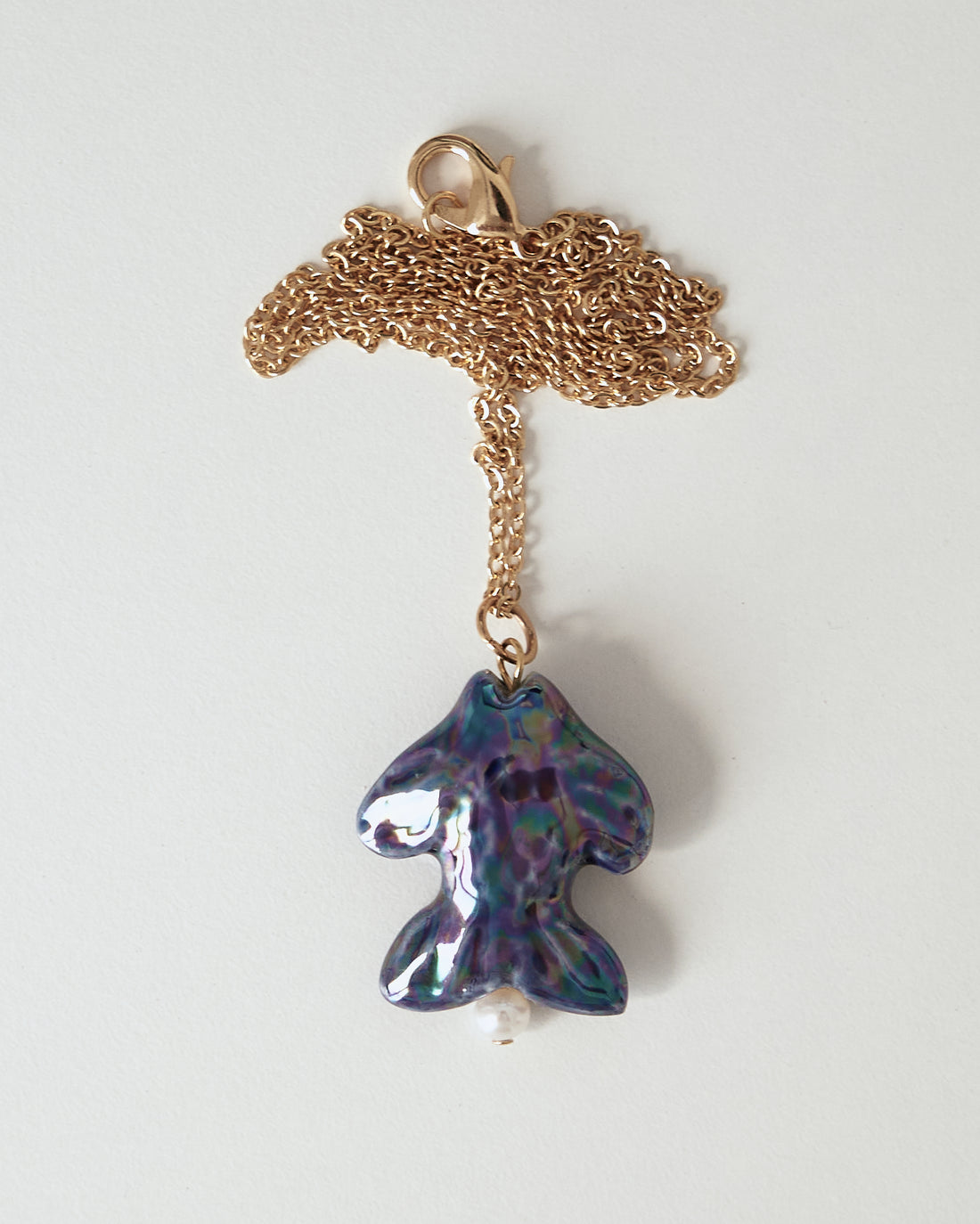 Khvyli dark blue fish pendant on a chain