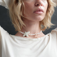 Myrni necklace with ear-shaped pearls and a porcelain bird