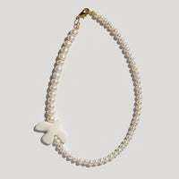 Myrni necklace with double-sized pearls and a porcelain bird