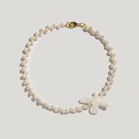 Myrni necklace with ear-shaped pearls and a porcelain bird