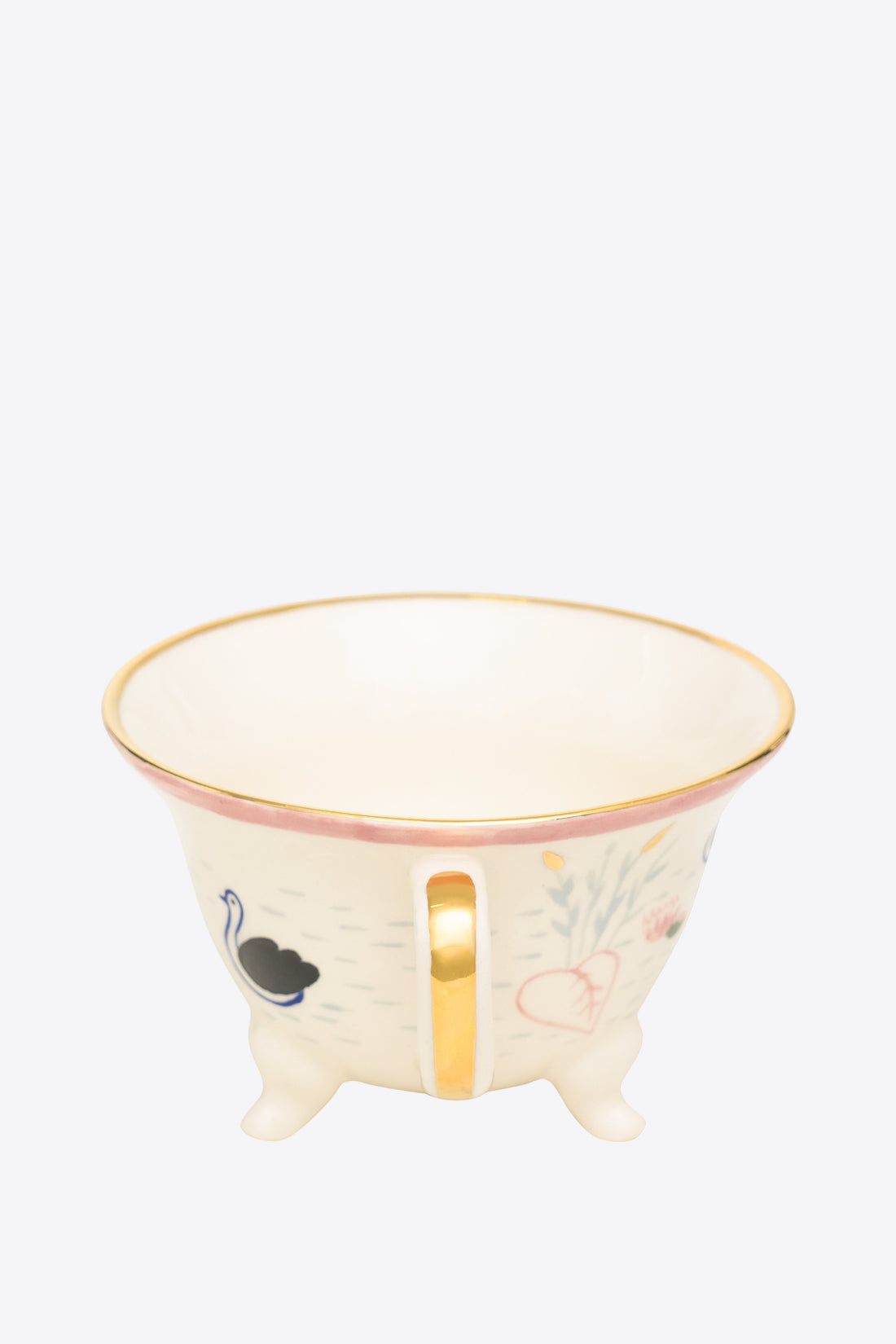 Decorative mug with gold rim and handle on a grey background