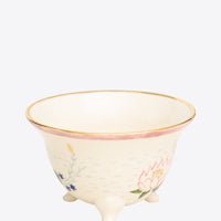Ceramic cup with floral design on a white background