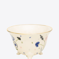 Ceramic cup with floral design on a white background