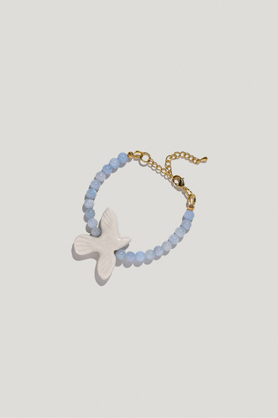 Myrni bracelet with blue quartz and a porcelain bird