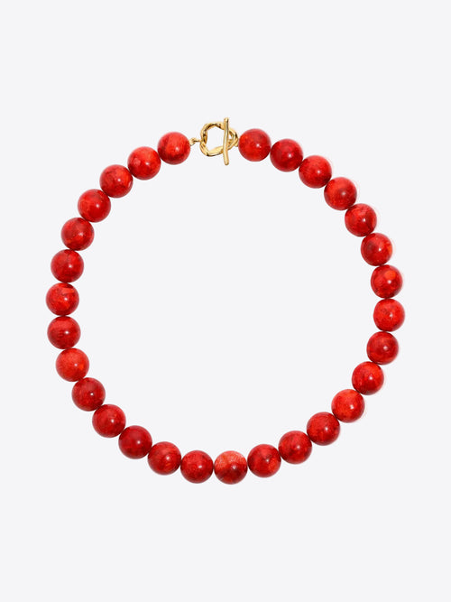 Red beaded necklace with a gold clasp on a white background