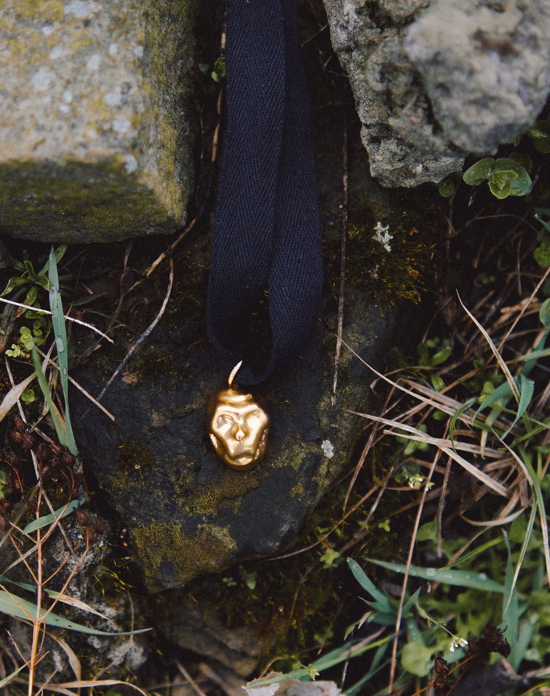 [P A M F I R]  small gold plated porcelain mask pendant on a cord