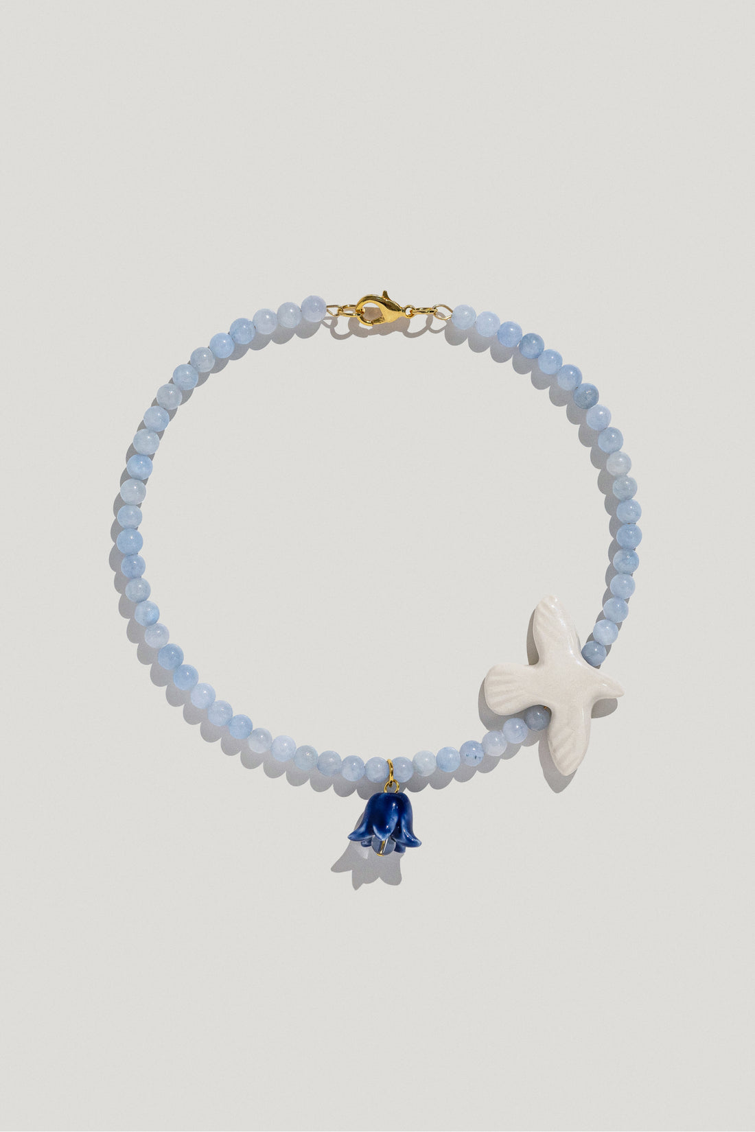 Polysk necklace with blue quartz, porcelain bird and flower