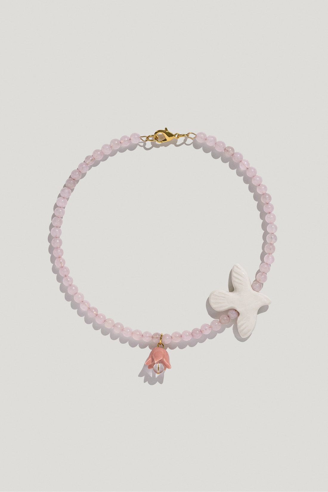 Polysk necklace with bubble-gum quartz, porcelain bird and flower