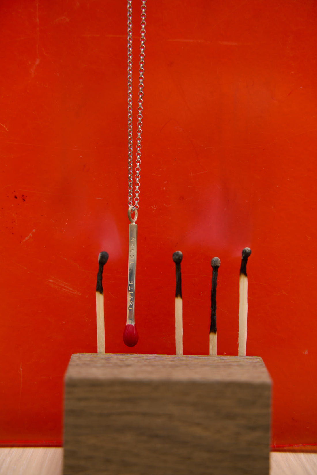 Pendant with red match