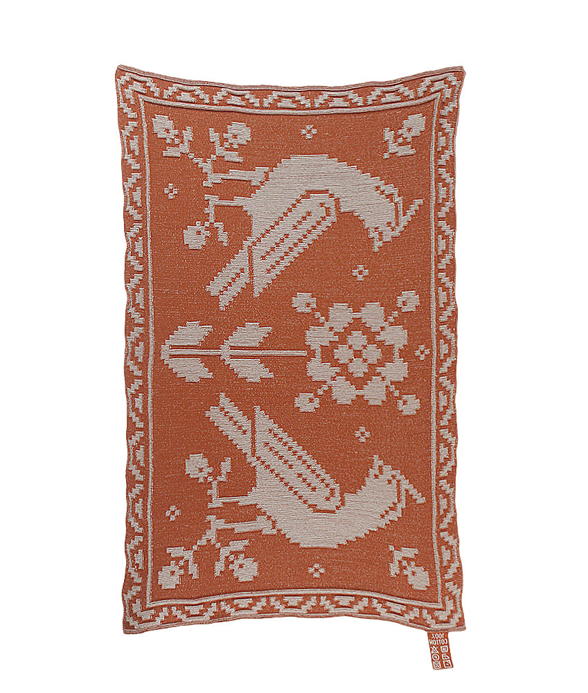 Blanket with birds and flowers in rust